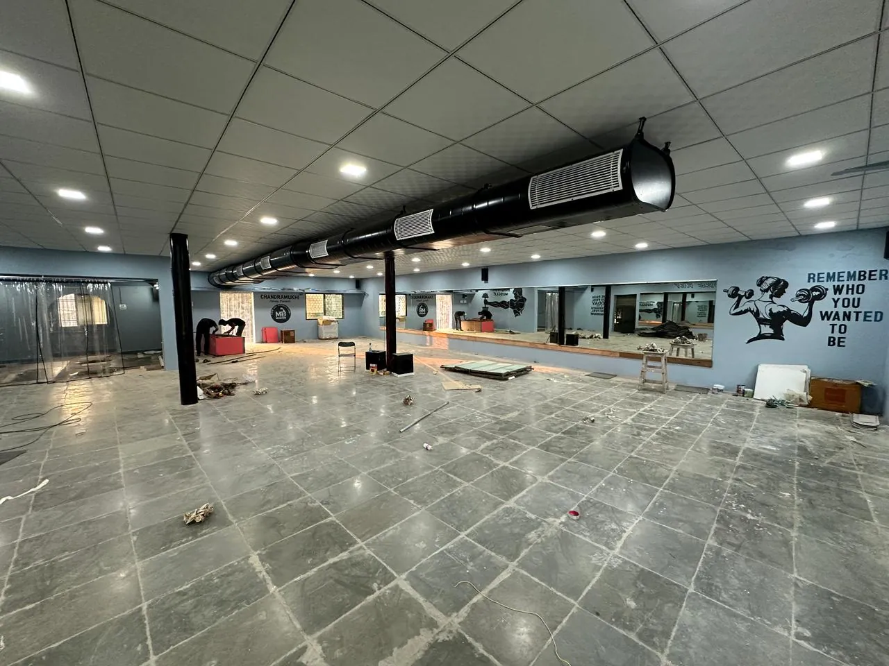 Capsule / oval GI ducting with outlets running across a large hall ceiling